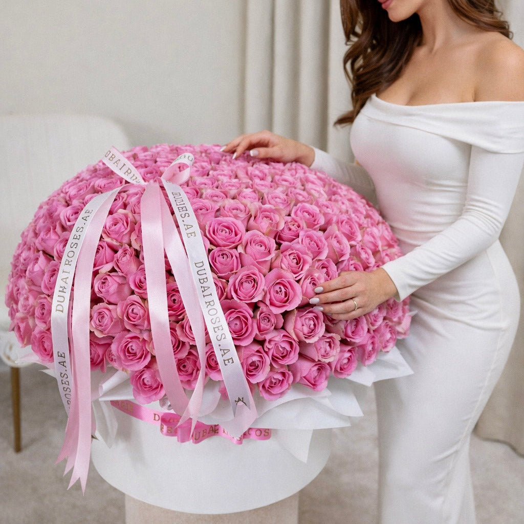 A close-up of a premium large-scale floral box featuring 200 dense, fresh pink roses in a professional designer black hatbox.