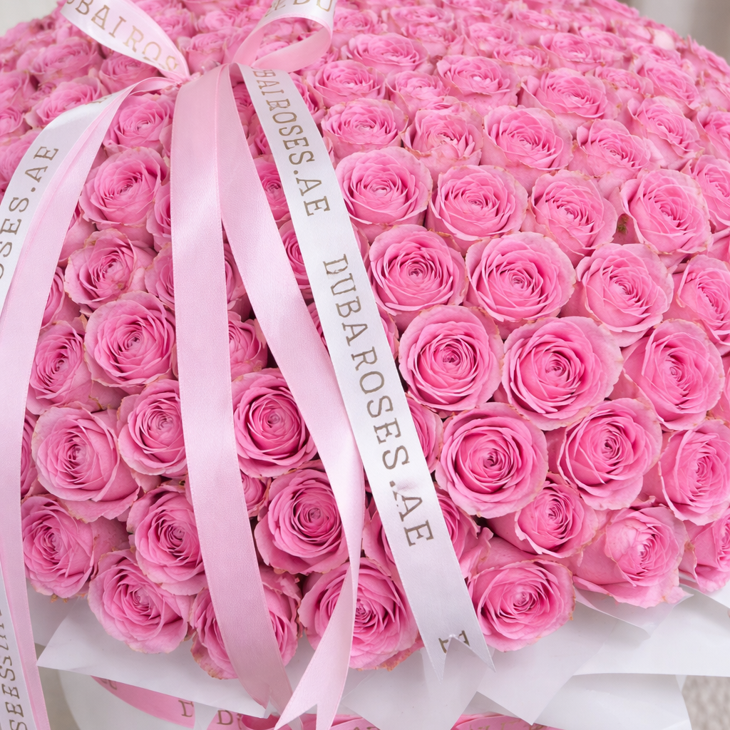 Bouquet of pink roses with a visible brand ribbon, 'Dubai Roses
