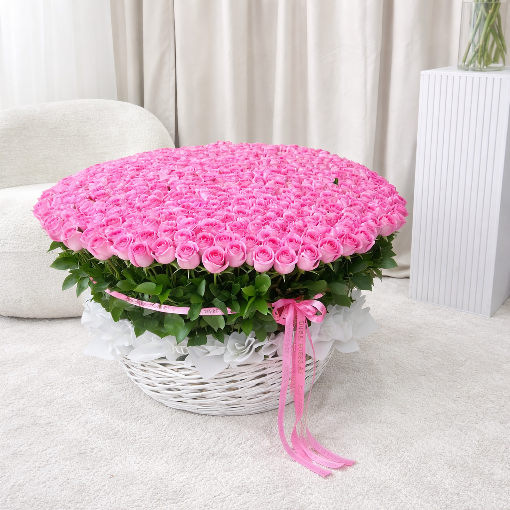 a top view of 500 pink roses in basket against a neutral background