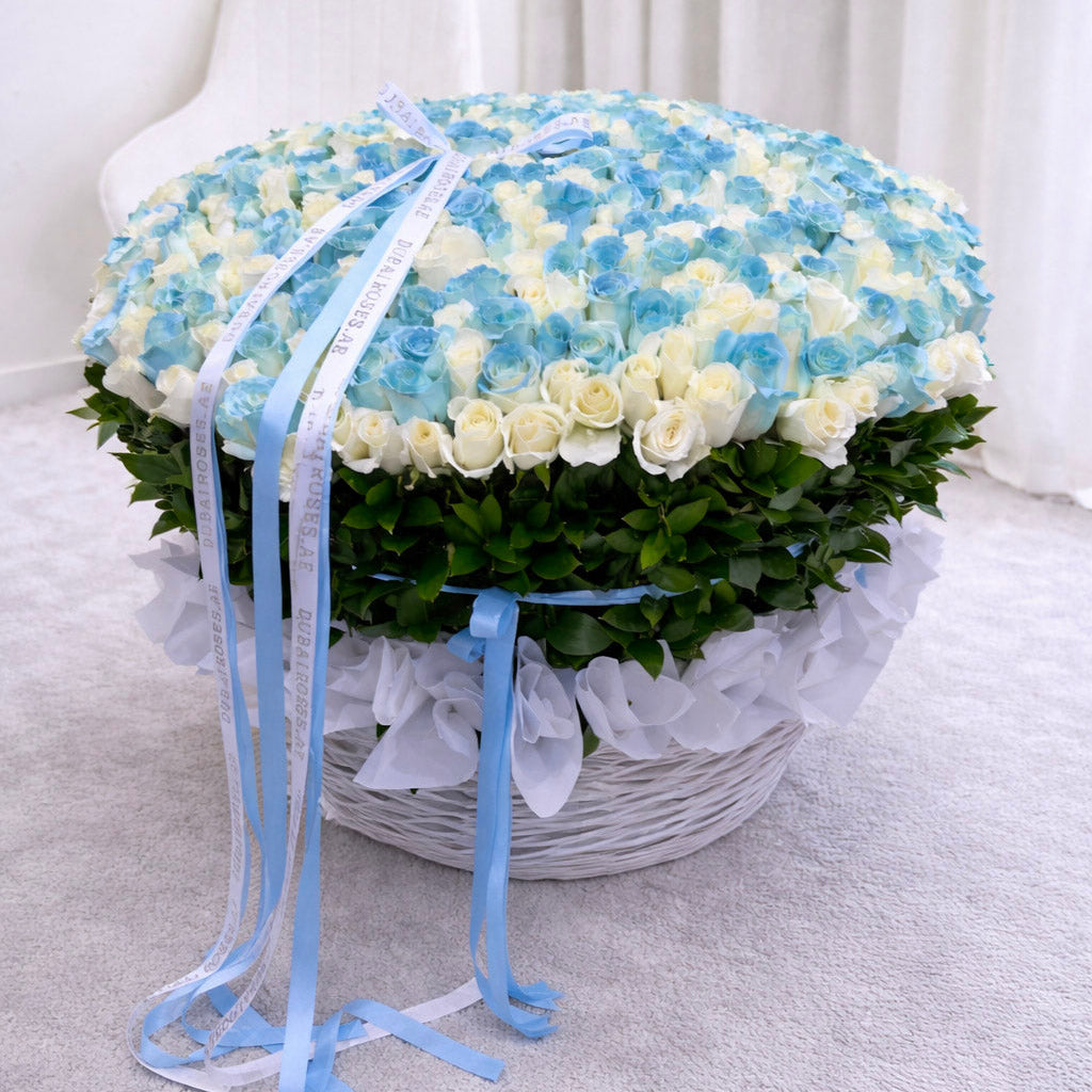 Floral arrangement in a basket with blue and white flowers on a light gray background