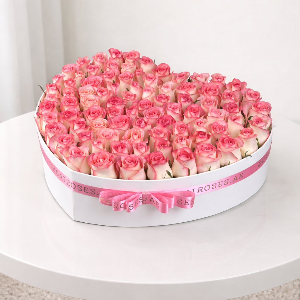 Heart-shaped arrangement of pink roses in a white box 