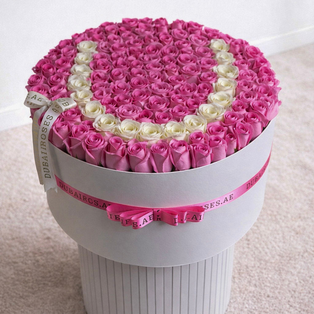 pink roses in round box with letter