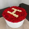 a box of roses with a letter s in it