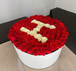 a box of roses with a letter s in it