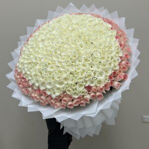 A big bouquet of white roses enclosed with light pink roses