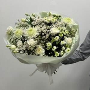 A bouquet composed of premium white chrysanthemum, white carnation, white vax, and white spray roses