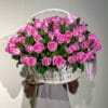 100 pink roses in basket with greens