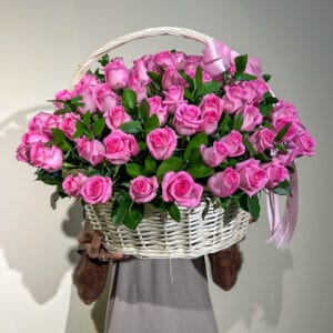 100 pink roses in basket with greens